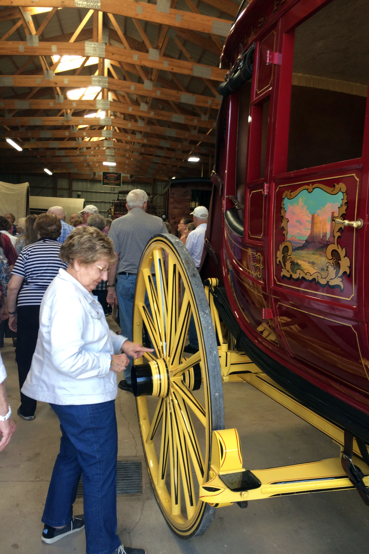 113 Elsie Goertzen examines the wheels on this coach.JPG